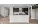 Stylish kitchen with a large island, stainless steel appliances, dark wood cabinets, and quartz countertops at 4960 Cinnabar Trl, Brownsburg, IN 46112