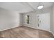 Open-concept room featuring wood-look flooring, neutral walls, modern light fixture, and natural light at 4960 Cinnabar Trl, Brownsburg, IN 46112