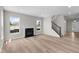 Bright and airy living room featuring large windows, a cozy fireplace, and easy access to the staircase at 4960 Cinnabar Trl, Brownsburg, IN 46112