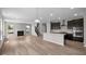 Spacious open concept living room and kitchen boasts hardwood floors, fireplace, and ample natural light at 4960 Cinnabar Trl, Brownsburg, IN 46112