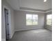 Expansive carpeted main bedroom showcasing windows letting in natural light at 4960 Cinnabar Trl, Brownsburg, IN 46112