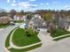Aerial view of a home featuring a well-manicured lawn, mature trees, and a two-car garage at 5312 Ripplingbrook Way, Carmel, IN 46033