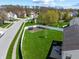 Aerial view of a home featuring a spacious lawn, mature trees, and a trampoline at 5312 Ripplingbrook Way, Carmel, IN 46033