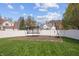 The backyard features a trampoline, basketball hoop, and large grass area at 5312 Ripplingbrook Way, Carmel, IN 46033
