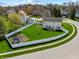 Aerial view of a large backyard with a white fence, trampoline, and green grass at 5312 Ripplingbrook Way, Carmel, IN 46033