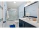 Stylish bathroom with white tiling, glass enclosed shower, and a striking navy vanity at 5312 Ripplingbrook Way, Carmel, IN 46033