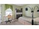 Comfortable bedroom with a full bed, adjacent desk area, and soft, neutral carpeting at 5312 Ripplingbrook Way, Carmel, IN 46033