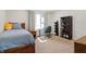 Cozy bedroom featuring a study desk setup, large window, and carpeted floors at 5312 Ripplingbrook Way, Carmel, IN 46033