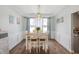 Inviting dining room with a wooden table, white chairs, and natural light from large windows at 5312 Ripplingbrook Way, Carmel, IN 46033