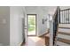 Entryway with hardwood floors, staircase, and a view of the front yard through the open door at 5312 Ripplingbrook Way, Carmel, IN 46033