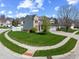Street view of a two-story brick home, landscaped lawn, and a two-car garage at 5312 Ripplingbrook Way, Carmel, IN 46033