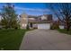 Beautiful two-story brick home with a large driveway and manicured lawn at 5312 Ripplingbrook Way, Carmel, IN 46033