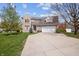 Well-manicured lawn with a brick two-story home and two-car garage at 5312 Ripplingbrook Way, Carmel, IN 46033