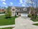 Charming two-story brick home with a well-maintained lawn and attached two-car garage at 5312 Ripplingbrook Way, Carmel, IN 46033
