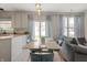 Kitchen with dining area, featuring stainless steel appliances and natural light from the sliding door at 5312 Ripplingbrook Way, Carmel, IN 46033