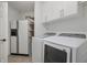 Clean laundry room featuring a washing machine and dryer, plus built-in shelving and cabinets at 5312 Ripplingbrook Way, Carmel, IN 46033