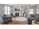 Cozy living room with a fireplace, comfortable seating, and hardwood floors at 5312 Ripplingbrook Way, Carmel, IN 46033