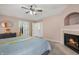 Relaxing main bedroom features a fireplace, neutral color scheme, and access to a walk-in closet at 5312 Ripplingbrook Way, Carmel, IN 46033
