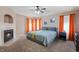 Cozy main bedroom features a fireplace, ceiling fan, and ample natural light at 5312 Ripplingbrook Way, Carmel, IN 46033
