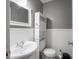 Well-lit half-bathroom with wainscotting and a pedestal sink at 5512 Straw Hat Dr, Indianapolis, IN 46237