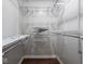 Walk-in closet with custom shelving and hardwood floors at 5512 Straw Hat Dr, Indianapolis, IN 46237