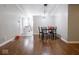 A dining room features wood floors and a modern light fixture hanging above the table at 5512 Straw Hat Dr, Indianapolis, IN 46237