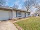 Close up of a single-story home with light blue shutters, attached garage, and walkway at 5512 Straw Hat Dr, Indianapolis, IN 46237