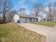 A charming single-story home with an attached garage and concrete driveway at 5512 Straw Hat Dr, Indianapolis, IN 46237