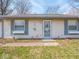 Close-up of the front of a single-story home with light blue shutters and a glass front door at 5512 Straw Hat Dr, Indianapolis, IN 46237