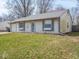Close-up of a single-story home with gray shutters, green lawn and attached garage at 5512 Straw Hat Dr, Indianapolis, IN 46237
