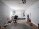 Large garage featuring a roll-up door, work area, and convenient access to the backyard at 5512 Straw Hat Dr, Indianapolis, IN 46237