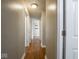 This hallway has hardwood floors and white trim at 5512 Straw Hat Dr, Indianapolis, IN 46237