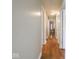 A hallway with wood floors and multiple rooms on each side at 5512 Straw Hat Dr, Indianapolis, IN 46237