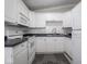 A kitchen features white cabinets, appliances, and tile backsplash at 5512 Straw Hat Dr, Indianapolis, IN 46237