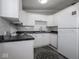 A kitchen features white cabinets, appliances, and tile backsplash at 5512 Straw Hat Dr, Indianapolis, IN 46237