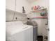Functional laundry room with shelving, Hotpoint washing machine, and water softener system at 5512 Straw Hat Dr, Indianapolis, IN 46237