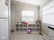 A mud room with tile floors and a white shelving unit at 5512 Straw Hat Dr, Indianapolis, IN 46237