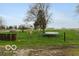 Backyard with a playset, trampoline and partial fence at 5973 Masten Rd, Coatesville, IN 46121