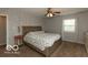 Traditional bedroom with a comfortable bed, dresser, and patterned wallpaper at 5973 Masten Rd, Coatesville, IN 46121