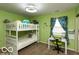Bright green bedroom with a bunk bed and writing desk at 5973 Masten Rd, Coatesville, IN 46121