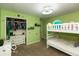 Bright green bedroom with a bunk bed and full closet at 5973 Masten Rd, Coatesville, IN 46121