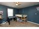 A bedroom with blue walls, a ceiling fan, a large window and a bunk bed at 5973 Masten Rd, Coatesville, IN 46121
