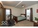 Bedroom with a stationary bike and a window with patterned curtains at 5973 Masten Rd, Coatesville, IN 46121