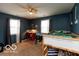 A bedroom with a bed, window, ceiling fan, and an aquarium, illuminated by natural light at 5973 Masten Rd, Coatesville, IN 46121