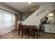 Traditional dining area showcases a wooden table near a staircase wall and window at 5973 Masten Rd, Coatesville, IN 46121