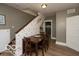 Traditional dining area showcases a wooden table near a staircase wall at 5973 Masten Rd, Coatesville, IN 46121