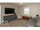 Spacious living room with a large TV, grey sofa and a side chair at 5973 Masten Rd, Coatesville, IN 46121
