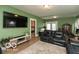 Comfortable living room featuring leather sofas, a large TV, and hardwood floors at 5973 Masten Rd, Coatesville, IN 46121