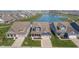 Beautiful aerial view of craftsman-style homes, well-manicured lawns, and serene pond with fountain feature at 622 Ehrlich Ln, Westfield, IN 46074
