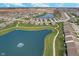 Panoramic aerial view of a beautiful community featuring a pond with fountains, green spaces, and winding walking paths at 622 Ehrlich Ln, Westfield, IN 46074